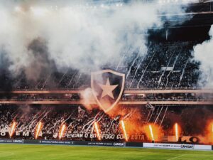 Dynamic scene of a stadium celebration with fireworks and cheering crowd.