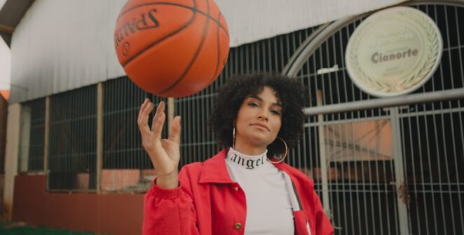 woman in red and white nike jersey holding basketball
