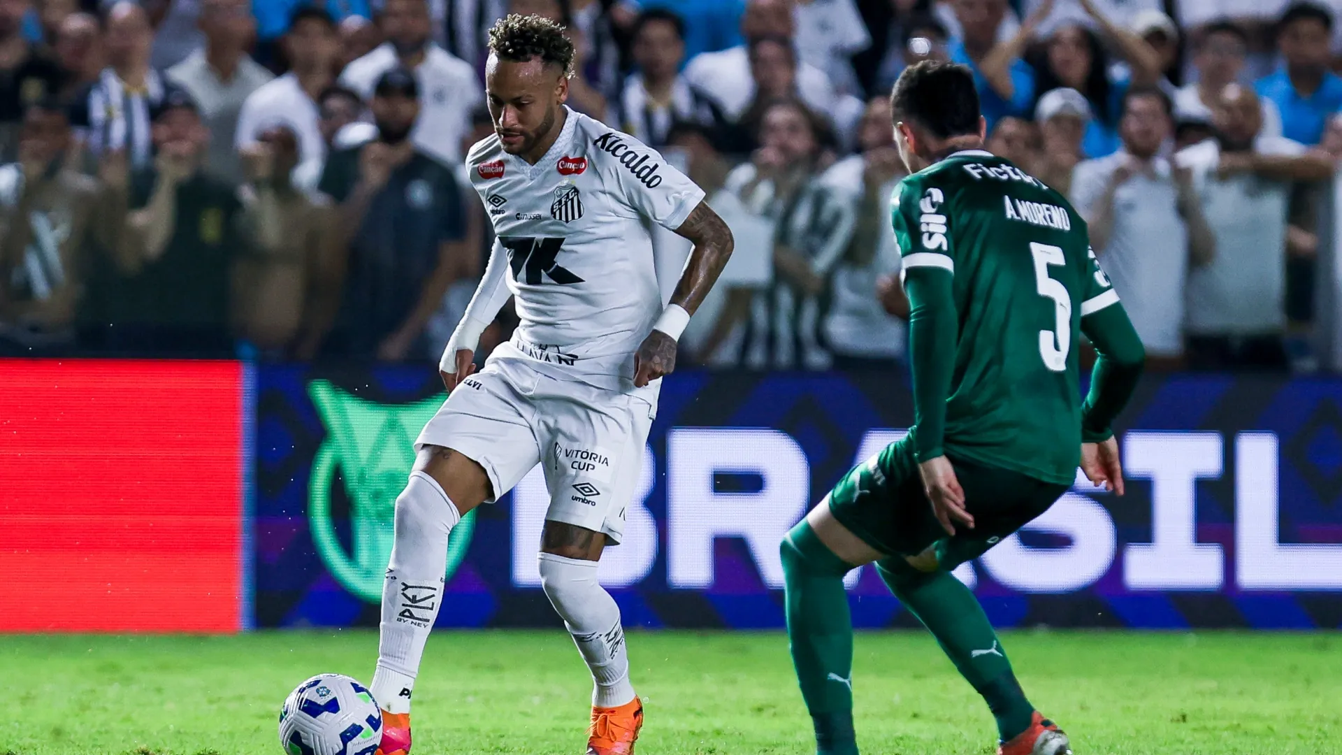 Neymar Junior of Santos plays the ball past Anibal Moreno of Palmeiras.