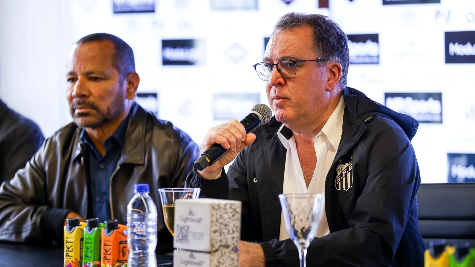 The Santos FC President Marcelo Teixeira speaks alongside Neymar da Silva Santos, Neymar Jr's father.
