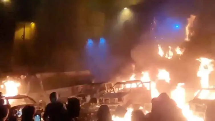 Protesters gather as vehicles burn, amid evolving anti-government unrest, in Tehran, Iran, in this screen grab obtained from a social media video released on January 9, 2026. Social Media/via REUTERS  THIS IMAGE HAS BEEN SUPPLIED BY A THIRD PARTY. NO RESALES. NO ARCHIVES. REFILE - QUALITY REPEAT  VERIFICATION: - Buildings, business signage and traffic light matched file and satellite imagery - Date not verified - Witnesses told Reuters protesters gathered in the streets on Thursday (January 8)