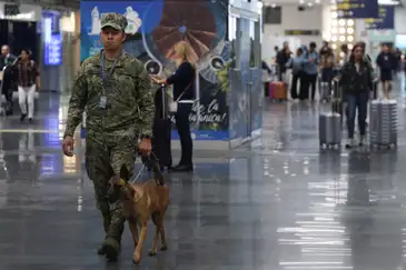 A member of the Mexican Navy K9 unit patrols Benito Juarez International Airport after authorities reinforced security following roadblocks and arson attacks carried out by organized crime in several states, after a military operation in which a government source said Mexican drug lord Nemesio Oseguera, known as “El Mencho,” was killed in Jalisco state, in Mexico City, Mexico, February 22, 2026. REUTERS/Luis Cortes