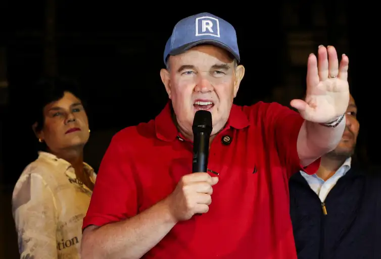Peru's presidential candidate Rafael Lopez Aliaga speaks as people gather outside Peru's electoral headquarters amid concerns about the voting process during the country's general election, in Lima, Peru, April 14, 2026. REUTERS/Manuel Orbegozo