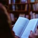person reading book in library