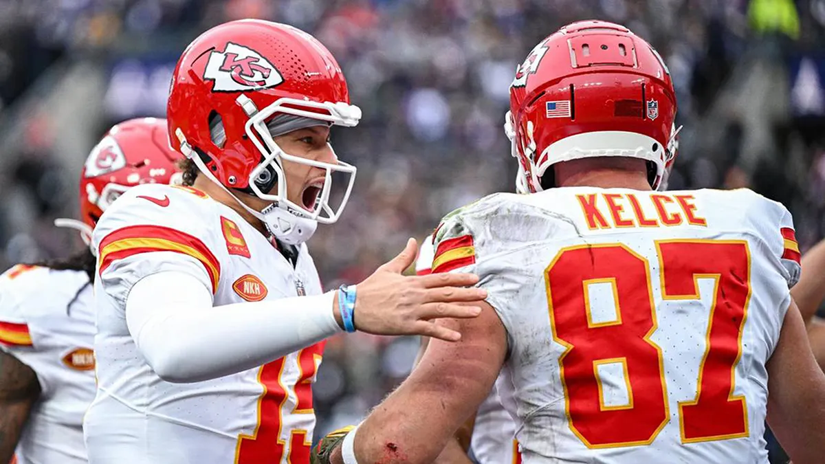 Patrick Mahomes and Travis Kelce celebrating after a touchdown catch during a football game