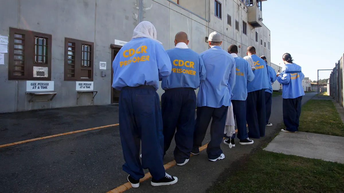 California prison inmtes line up outside.