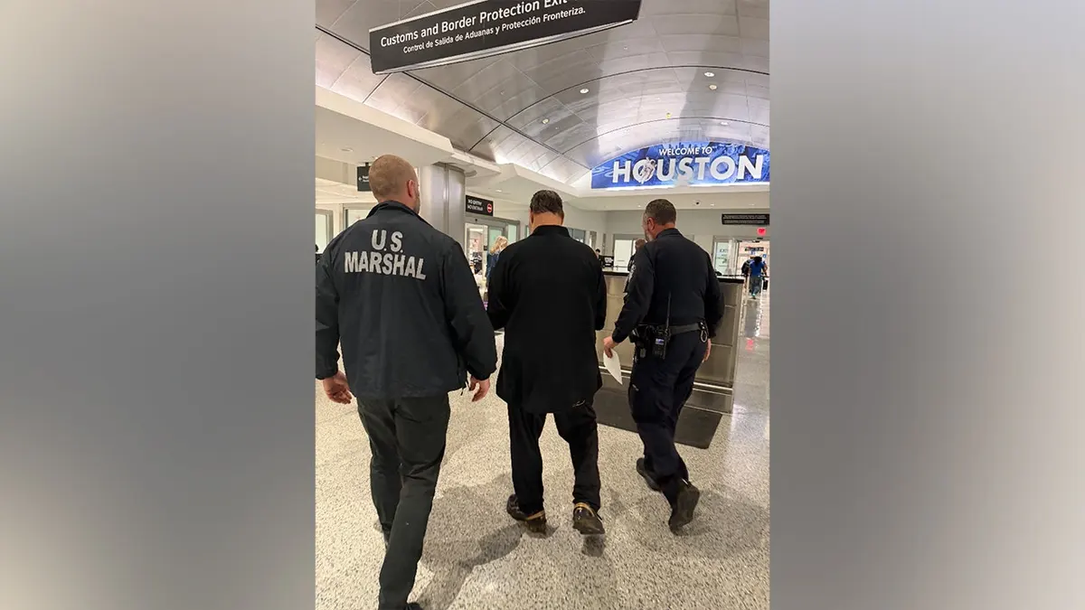 Richard Werstine standing in handcuffs during arrest in Panama City