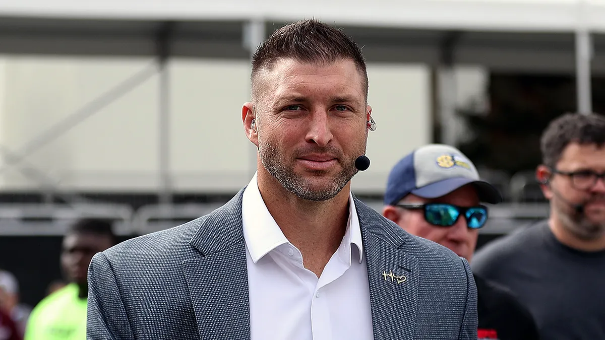 Tim Tebow standing outdoors on the SEC Nation set at Davis Wade Stadium.