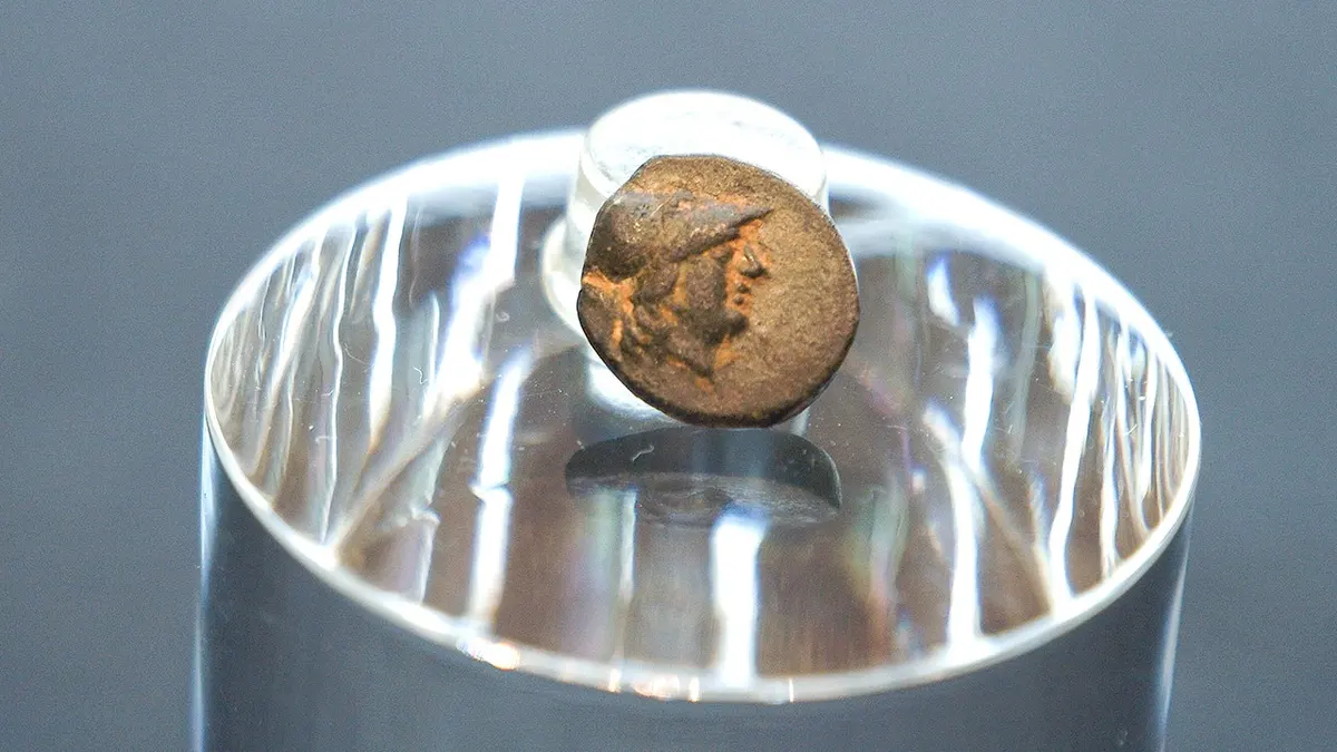 Small Greek coin on display at museum