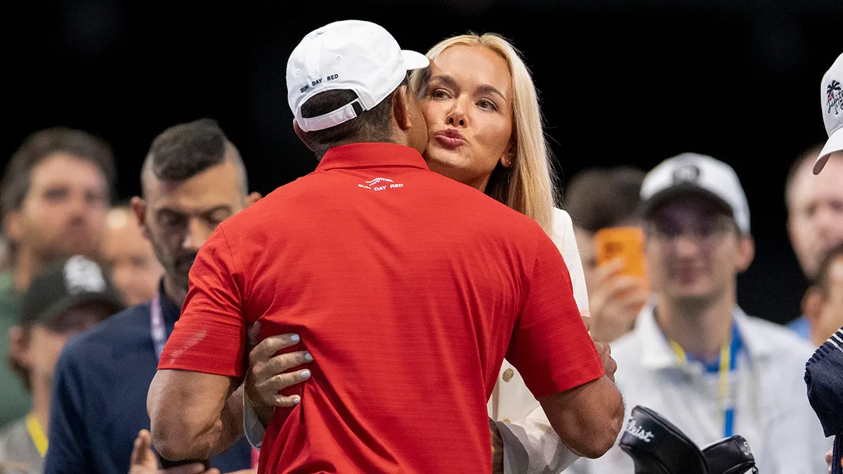 Tiger Woods receiving a hug and kiss from Vanessa Trump at SoFi Center