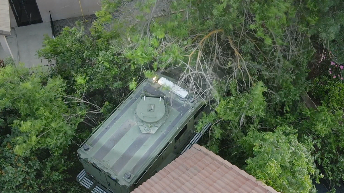 Kern County Sheriff’s Office BearCat armored vehicle moves through backyard during deadly Porterville standoff