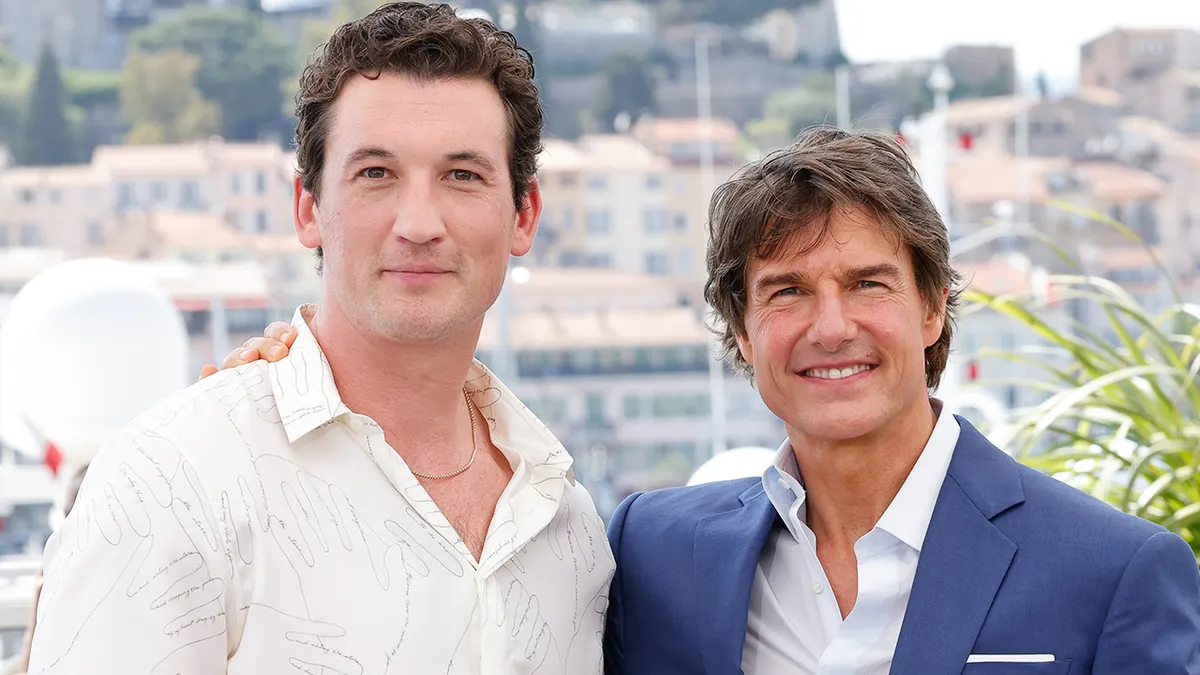 Miles Teller and Tom Cruise standing together at a photocall event in Cannes, France