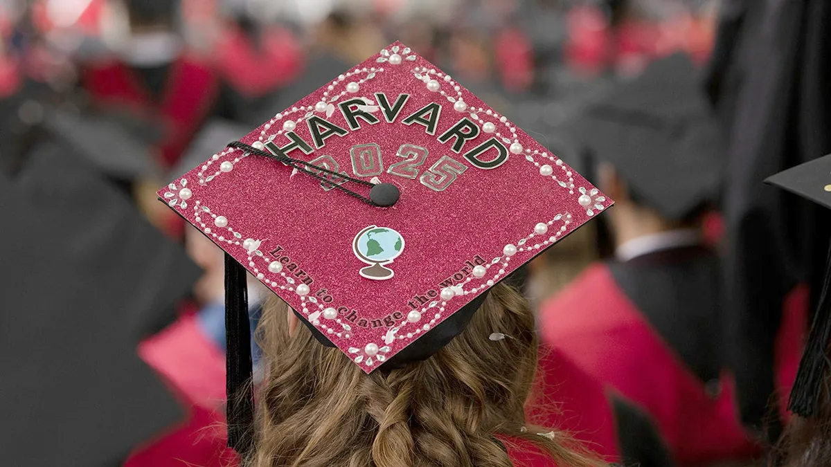 Harvard graduate wearing a graduation cap