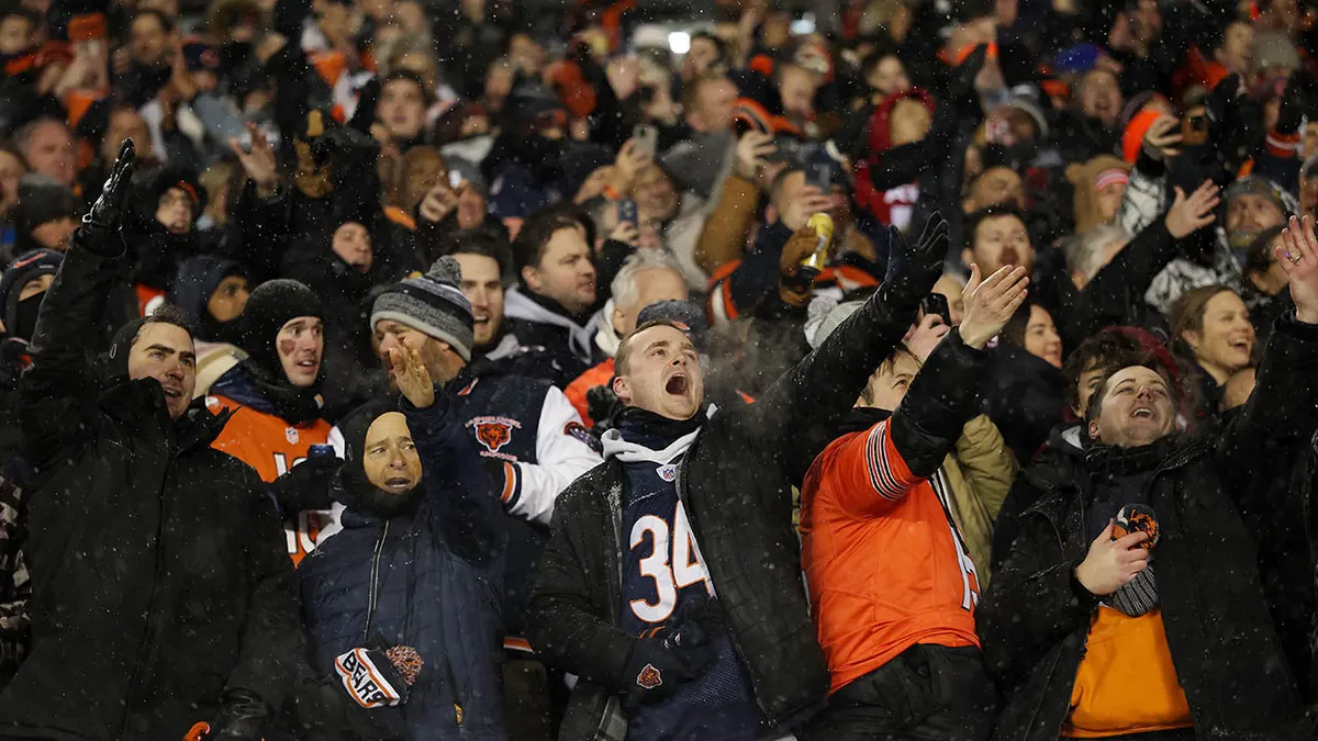 Fans cheering in the stands at Soldier Field before the Chicago Bears and Los Angeles Rams game
