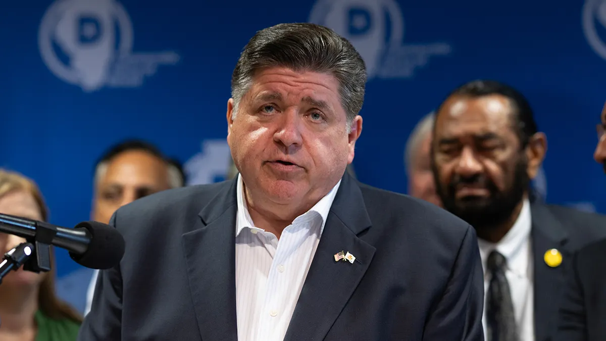 Illinois Gov. JB Pritzker speaking at a press conference in Aurora union hall