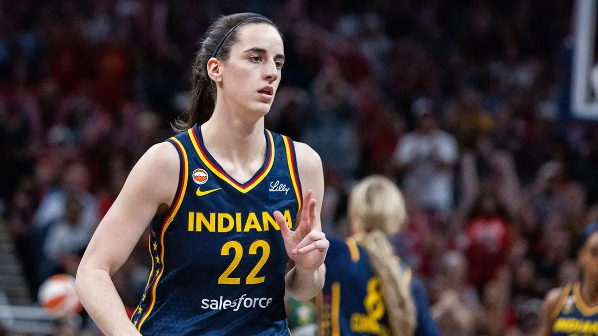 Indiana Fever guard Caitlin Clark celebrating a basket during a basketball game.