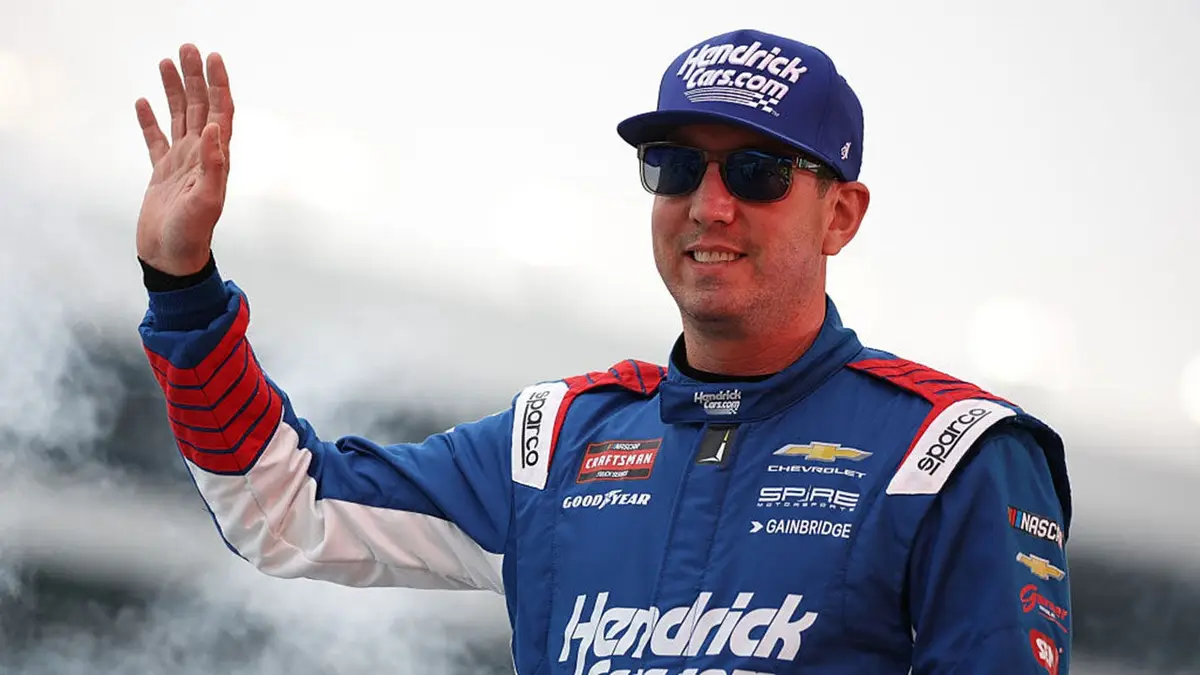 Kyle Busch standing in racing suit at Texas Motor Speedway