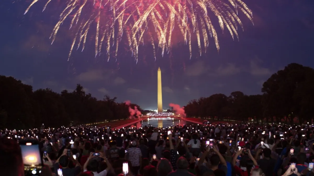 WASHINGTON, DISTRICT OF COLUMBIA, UNITED STATES - 2024/07/04: Attendees watch the Independence Day fireworks display along the National Mall in Washington, DC. (Photo by Probal Rashid/LightRocket via Getty Images)