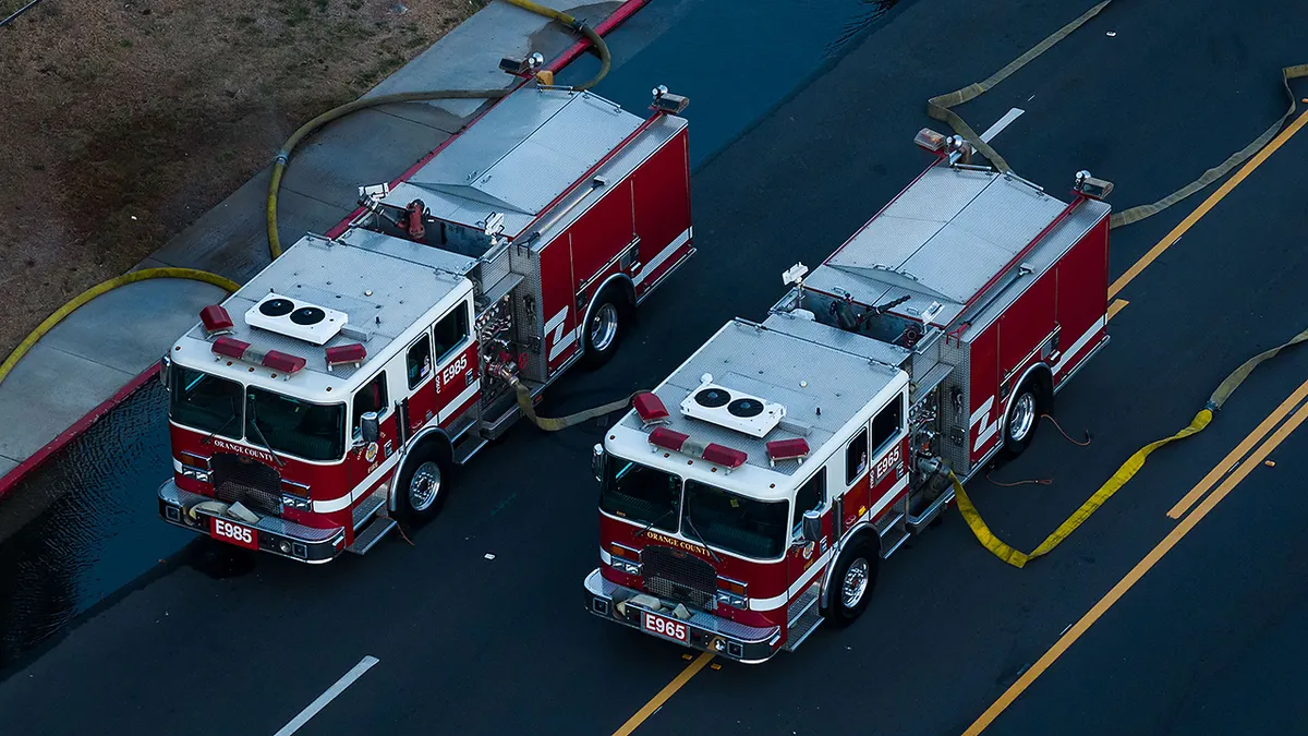 Firefighter trucks pumping water to a chemical tank at an aerospace plant