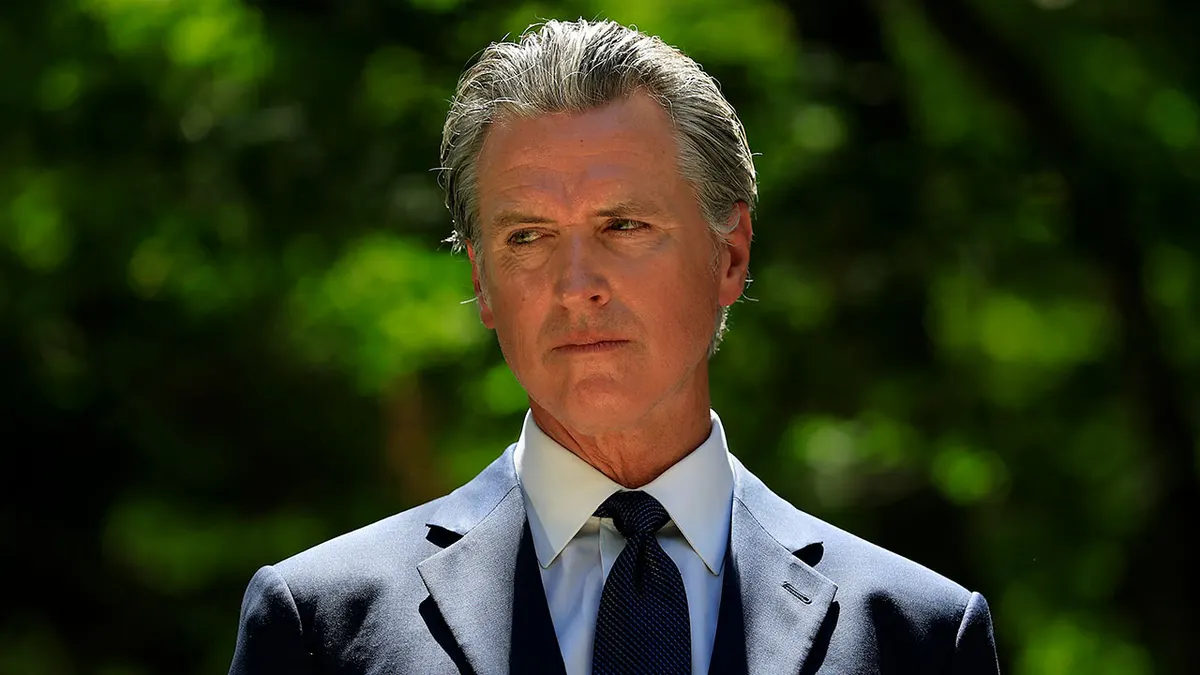 California Gov. Gavin Newsom looking on during news conference with Texas lawmakers