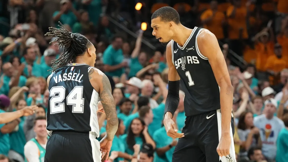 San Antonio Spurs forward Victor Wembanyama and guard Devin Vassell reacting during a basketball game