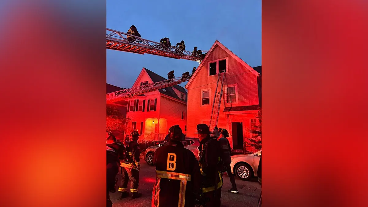 Firefighters battle a three-alarm house fire in Dorchester, Massachusetts