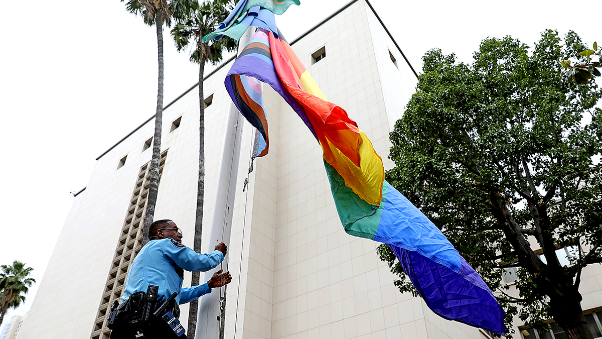 Progress Pride flag being raised over LA County building in 2023.