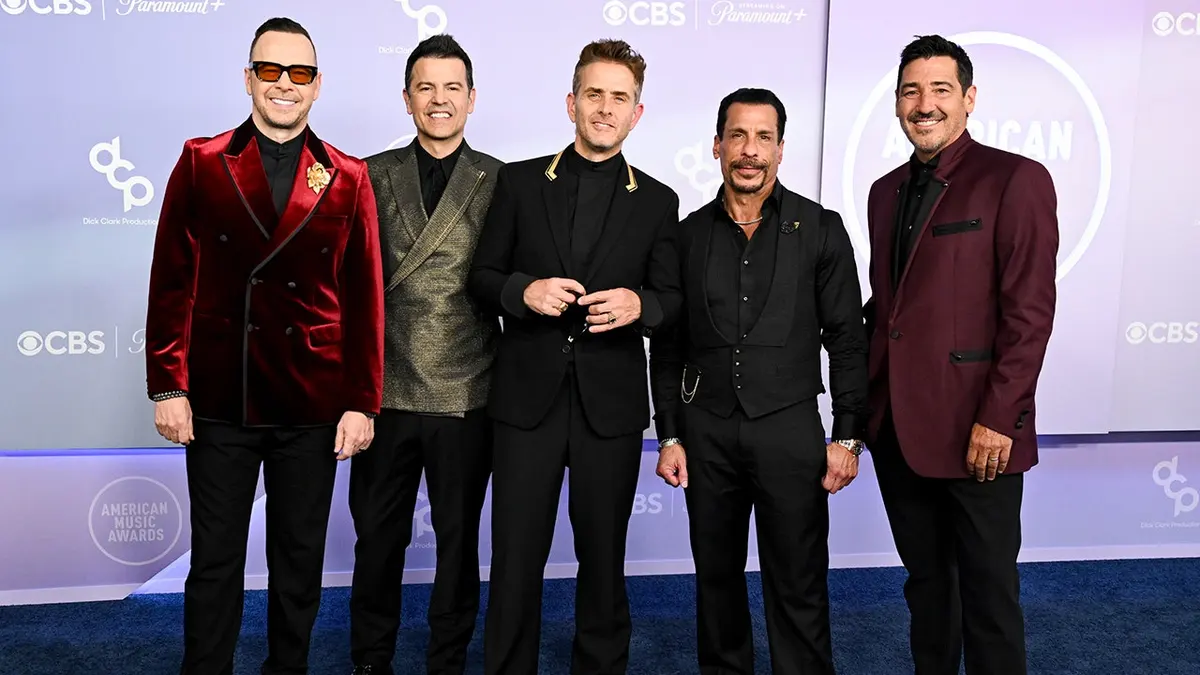 Donnie Wahlberg, Jordan Knight, Joey McIntyre, Danny Wood and Jonathan Knight standing together at the American Music Awards