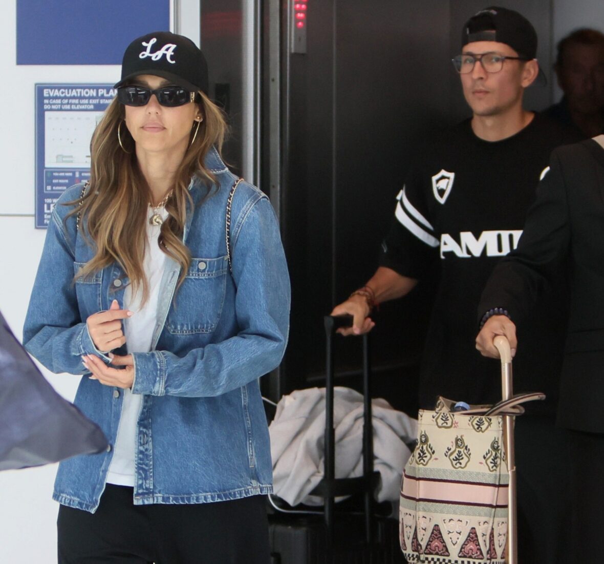 Jessica Alba e Danny Ramirez caminhando juntos no LAX