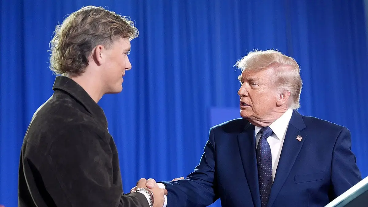 President Donald Trump shaking hands with New York Giants quarterback Jaxson Dart at Rockland Community College