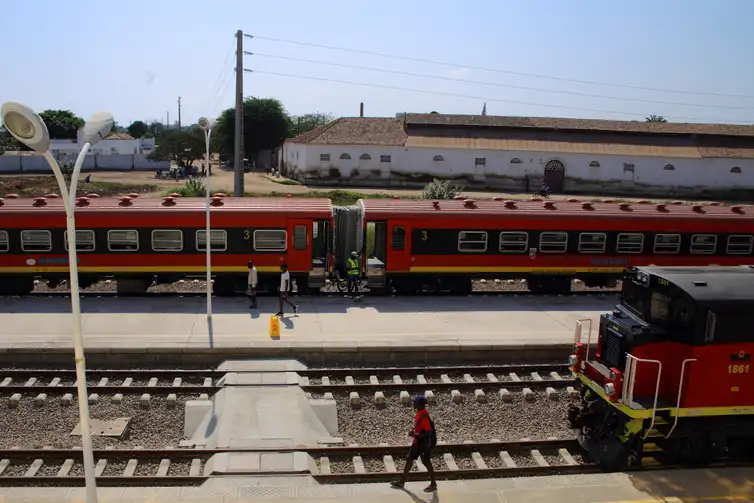 Locals walk past trains parked at Lobito station, which forms part of the Benguela Railway line, in Lobito, western Angola, July 23, 2021. The railway, part of the U.S.-backed Lobito Corridor, is a key transport link for regional trade. REUTERS/Cesar Muginga