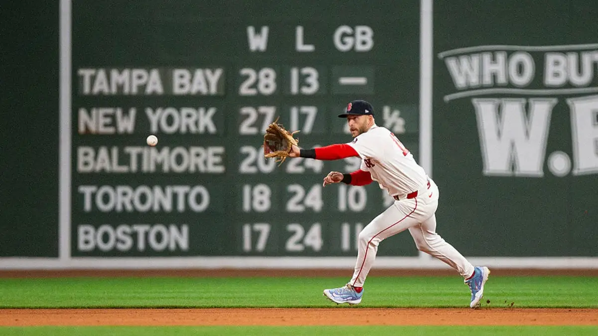 Trevor Story fields a baseball during a game at Fenway Park in Boston