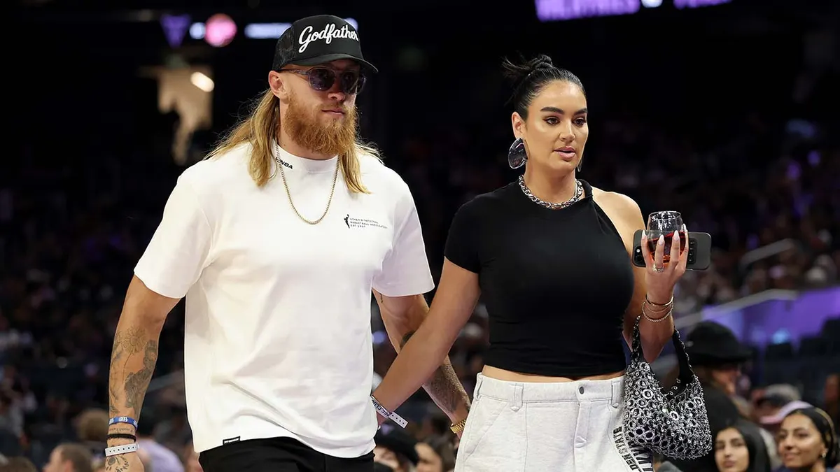 San Francisco 49ers tight end George Kittle and his wife Claire Kittle walking beside the court at Chase Center