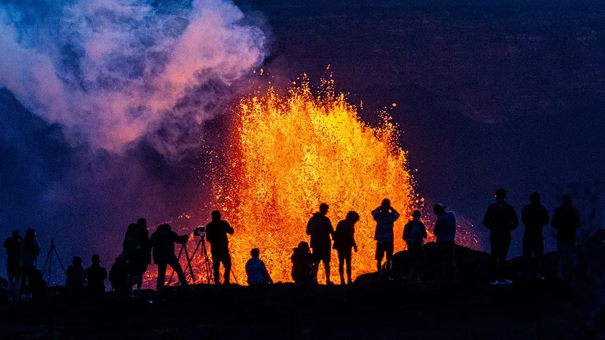 People watch as Hawaii's Kilauea Volcano erupts
