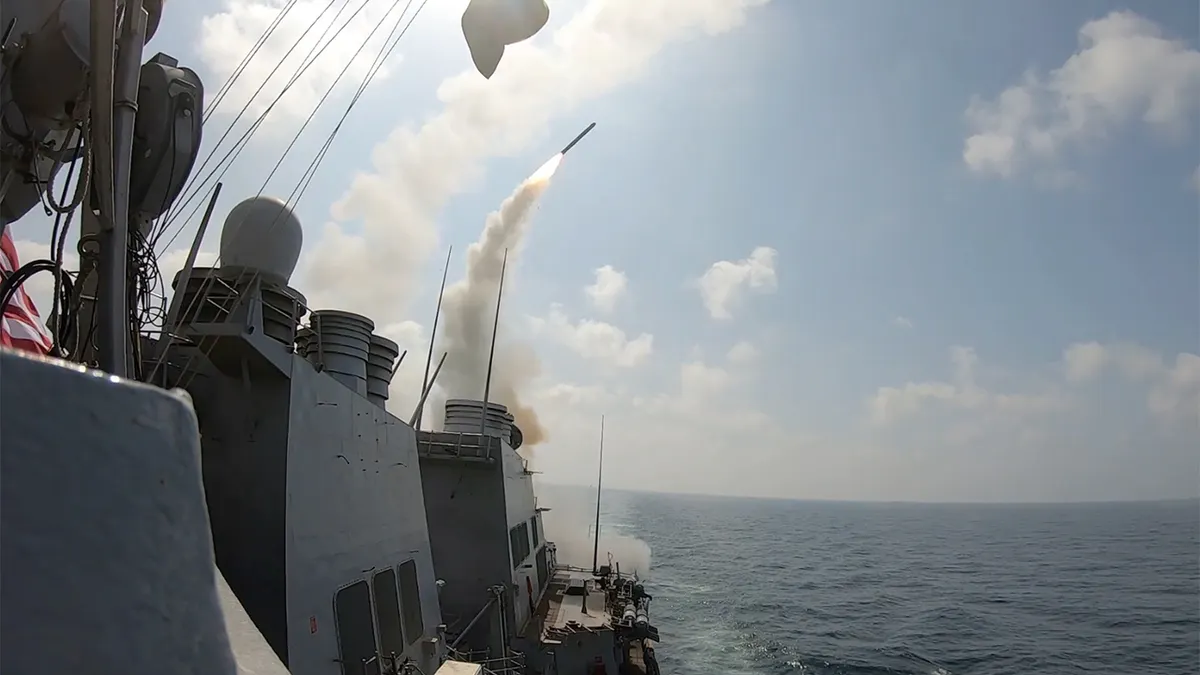 A U.S. Navy ship launching Tomahawk Land Attack Missiles at sea