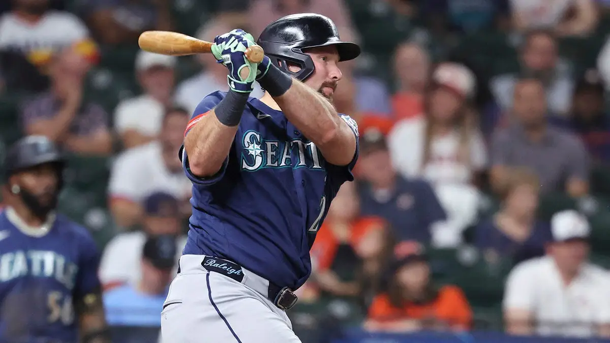Seattle Mariners catcher Cal Raleigh hitting a single at Daikin Park in Houston