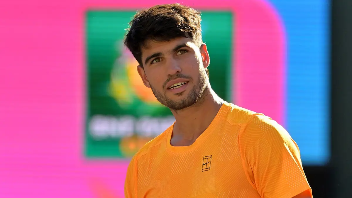 Carlos Alcaraz pumps his fist on tennis court at Indian Wells Tennis Garden