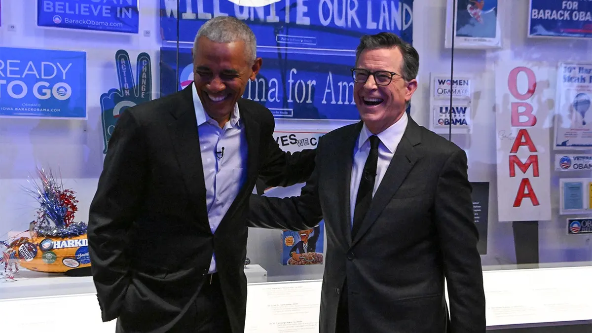 President Barack Obama and Stephen Colbert seated together on a television set