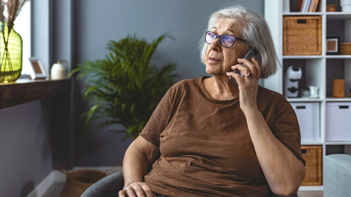 Senior retiree talking on phone indoors