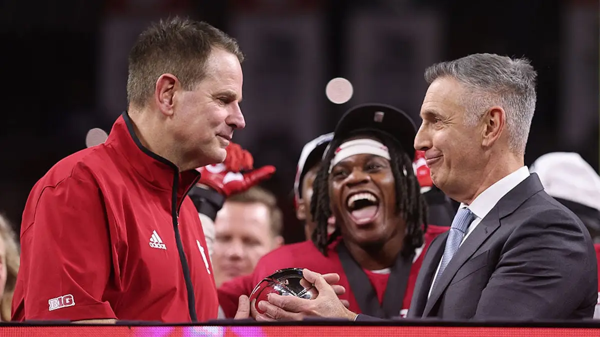 Big Ten Commissioner Tony Petitti presenting trophy to Curt Cignetti at Lucas Oil Stadium