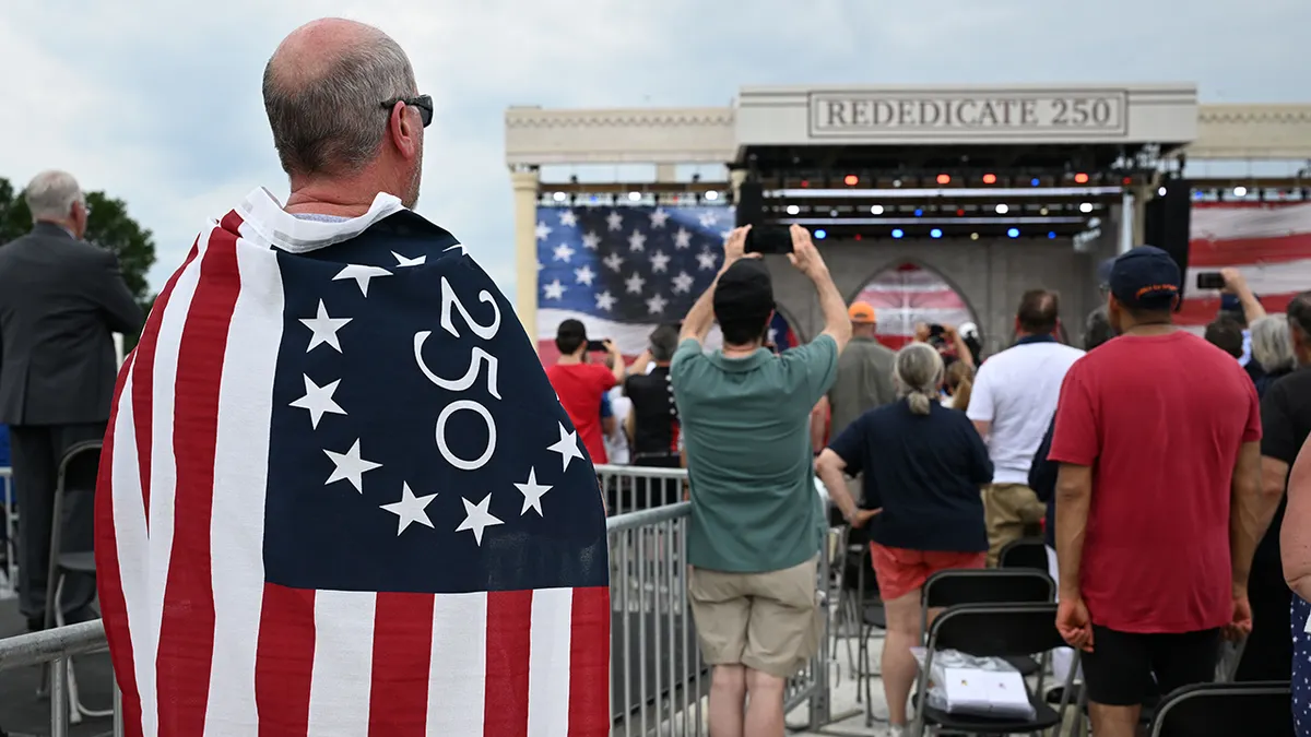 Attendees stand for the US National Anthem during the National Jubilee of Prayer, Praise & Thanksgiving on the National Mal