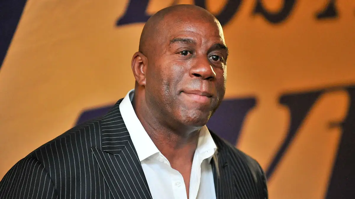 Magic Johnson standing courtside at a basketball game at Staples Center
