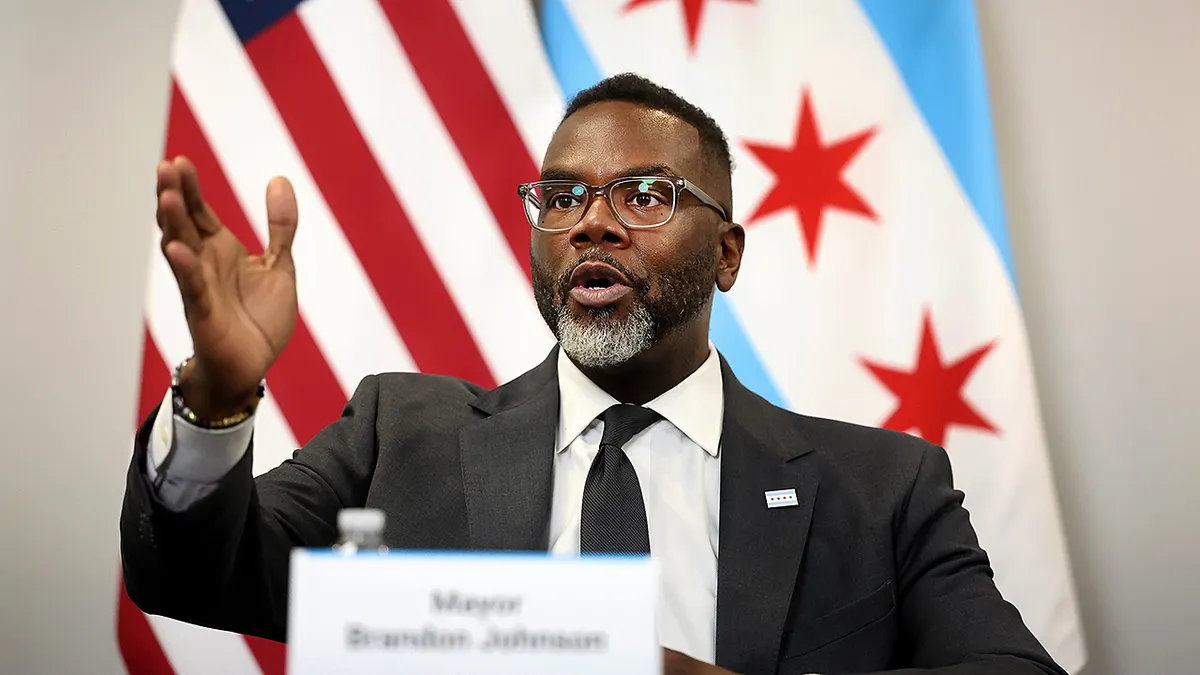Chicago Mayor Brandon Johnson speaking at a press conference inside City Hall.
