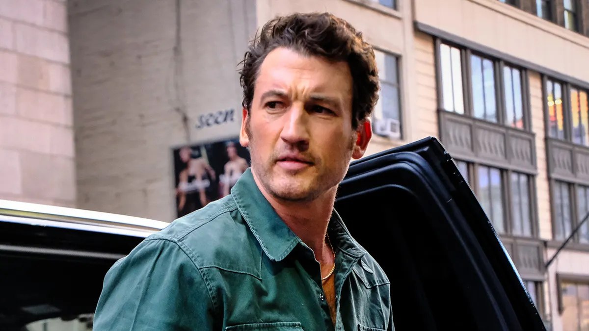 Miles Teller standing outdoors in New York City.