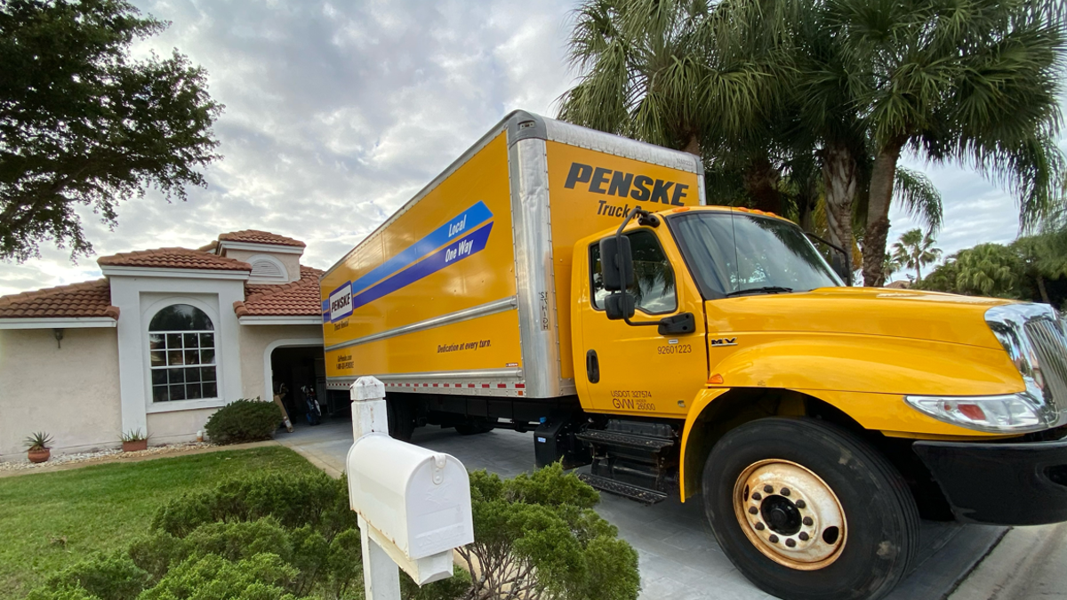 Penske moving truck parked in driveway of home in Palm Beach Gardens Florida