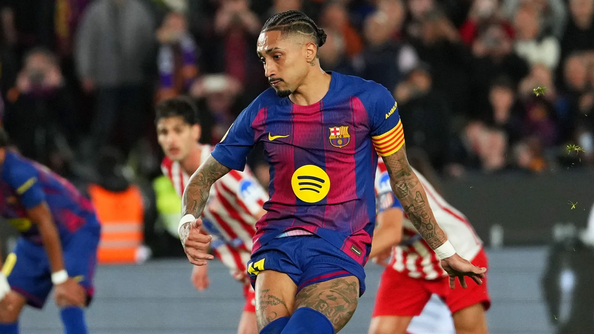 Raphinha of FC Barcelona scores against Atletico Madrid.