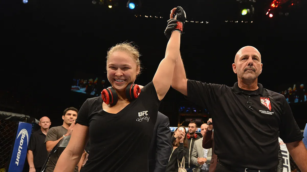 Ronda Rousey celebrating victory inside Mandalay Bay Events Center