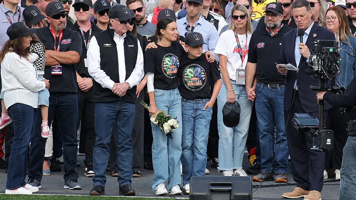 Richard Childress, Samantha Busch, Brexton Busch, and Steve O’Donnell standing on NASCAR grid