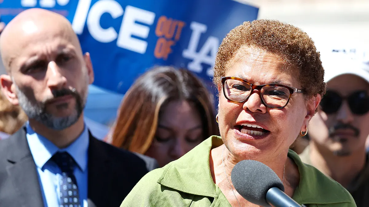 Los Angeles Mayor Karen Bass speaking with immigrant community leaders outside a Home Depot.