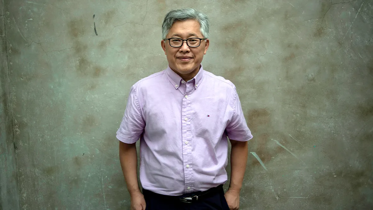 Ezra Jin Mingri standing indoors looking composed after church closure